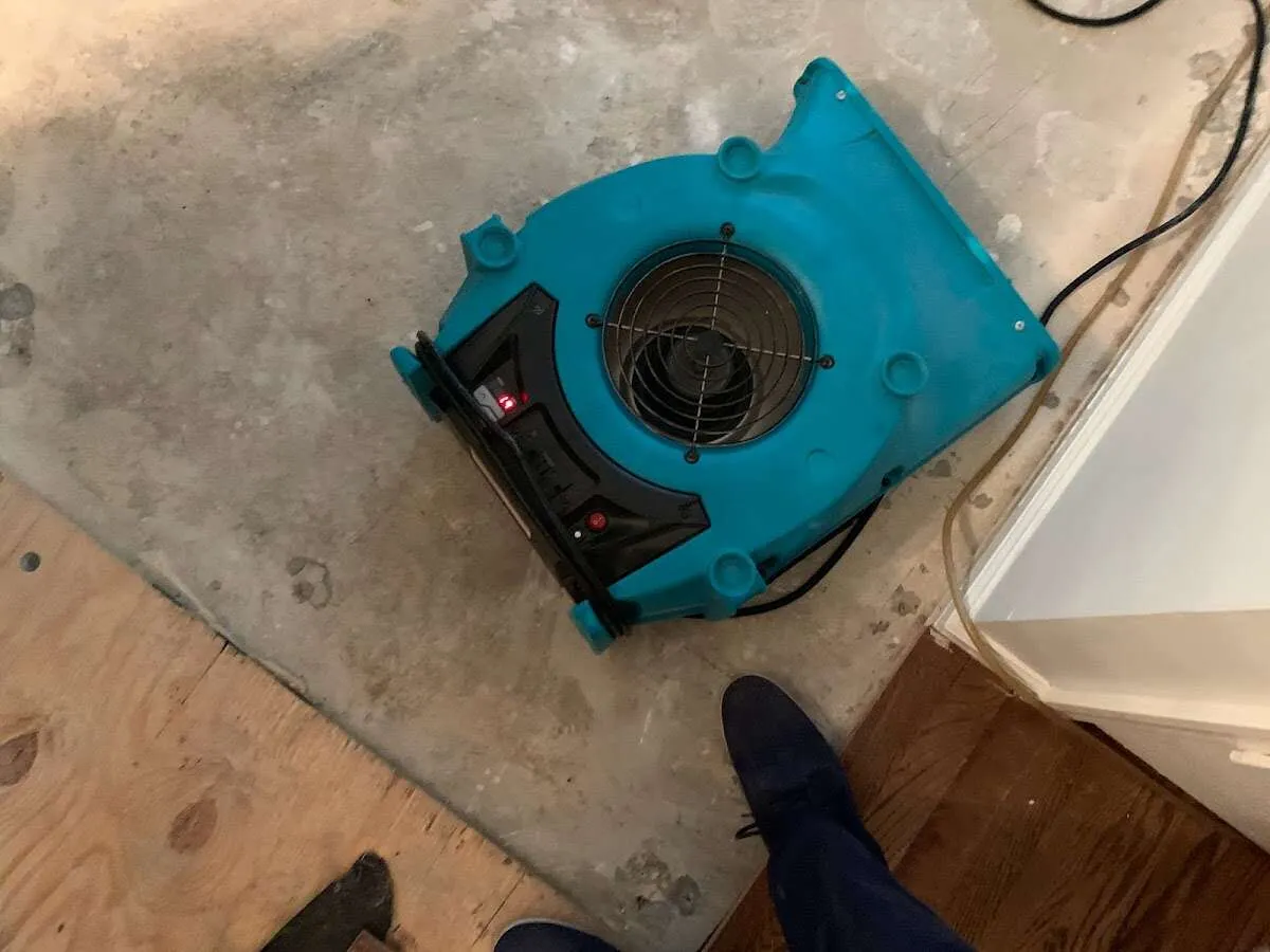 Air mover drying subfloor during Commercial Water Damage Restoration in Galax